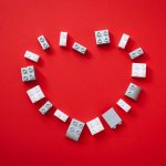 Love heart on a red background, made out of lego